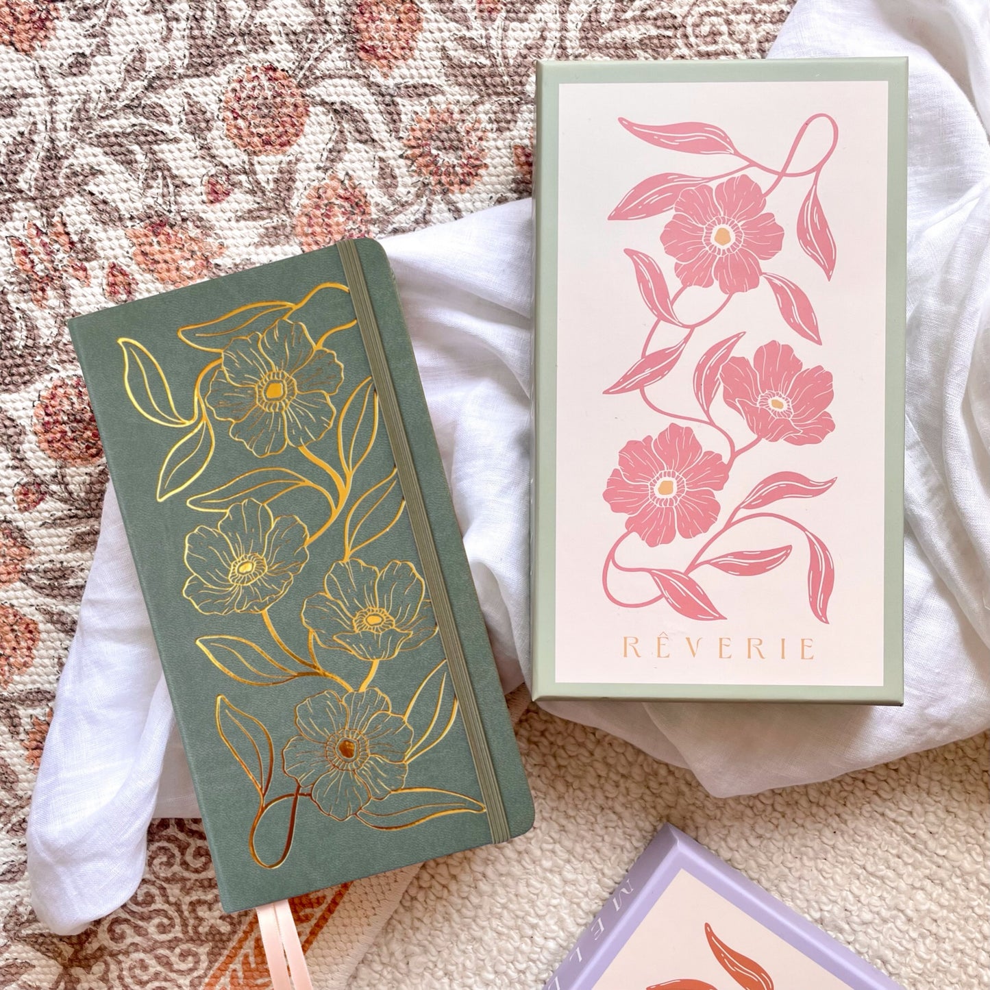 Reverie Traveler Size Journal in a sage green color with gold foil floral design on cover. With watercolor dotted paper
