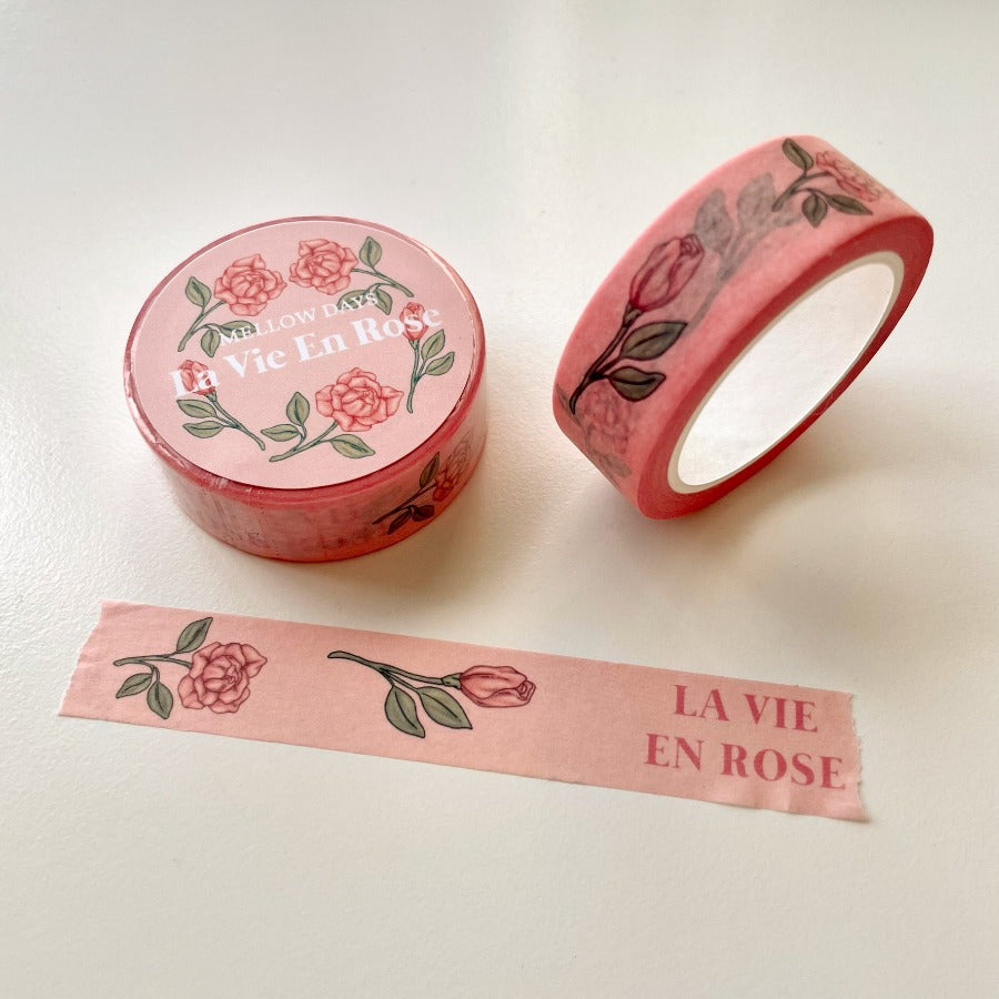 Rose blossom flowers printed on a light pink washi tape, along with the words, La Vie en Rose. 15 mm width by 10 meters length