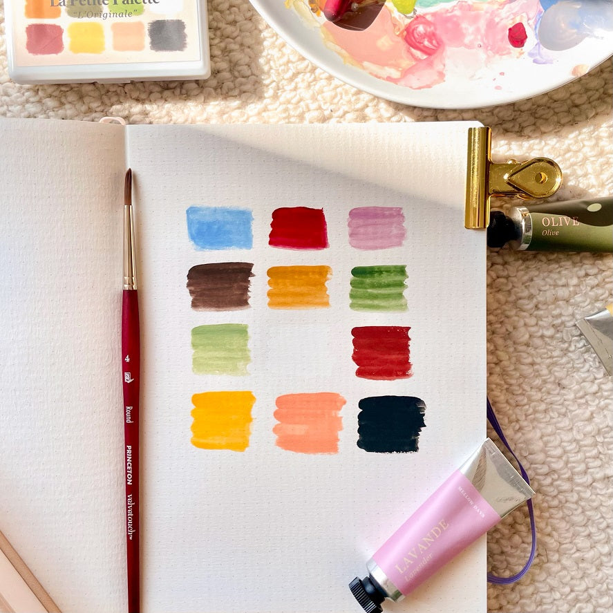 la petite palette by mellow days is gouache paint. featuring 12 unique paint colors swatch. sky blue, cherry red, lavender purple, coffee brown, mustard yellow, olive green, sage green, cotton white, terracotta, lemon yellow, peach, and night black