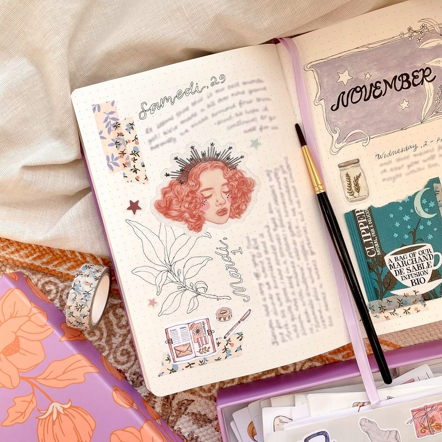 a journal page with la reveuse sticker decorating the center of the page