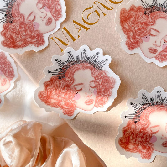 la reveuse vinyl sticker is 76 mm by 62 mm, illustrated with a pretty girls face with short curly hair and a star trimmed crown